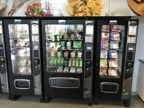Vending machine containing Simplot meals and fitted with cashless payment system for prepaid cards, credit cards, contactless and mobile payments.
